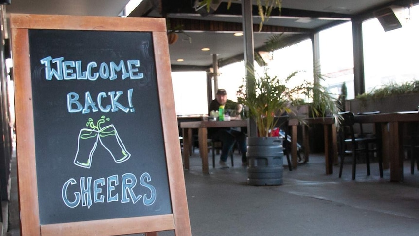 A sign outside Bentspoke says 'welcome back, cheers!'