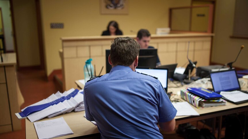 A police prosecutor examines notes at court in Warburton, WA.