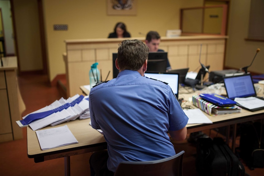 A police prosecutor examines notes at court in Warburton, WA.