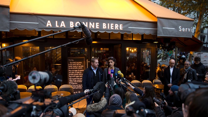 Managers of the bar deliver a press conference in front of the cafe during the reopening.