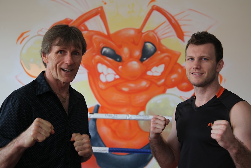 Glenn Rushton and Jeff Horn with their fists clenched