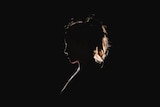 A silhouette of a woman's head and shoulders 