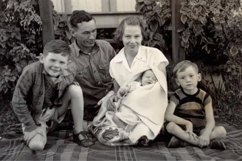 An old black and white photo of a young family 