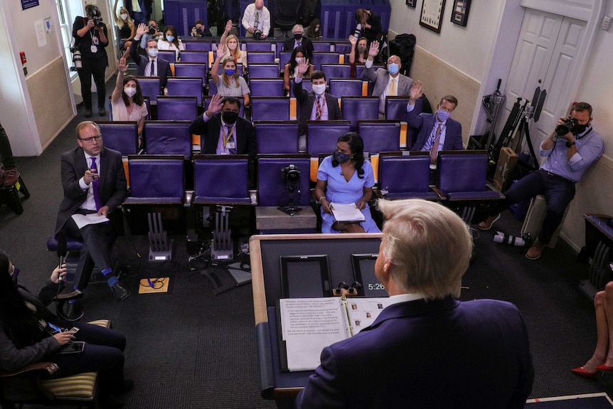 A photo taken from behind Donald Trump of the White House press briefing room