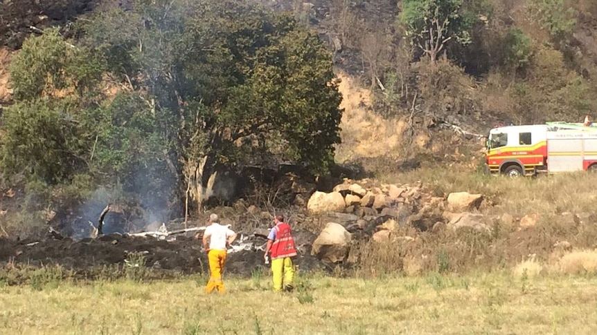Firefighters at the scene of the gyrocopter crash, west of Gatton
