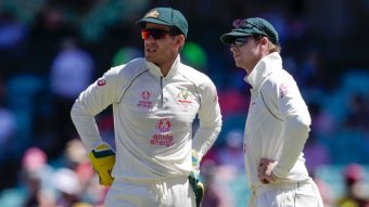 Tim Paine speaking to Steve Smith