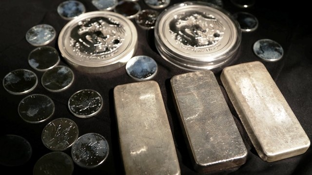 Rows of silver bars and coins.