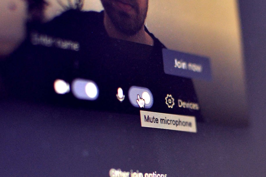 A cursor hovers over the mute microphone button in the video conferencing mode of Microsoft Teams.