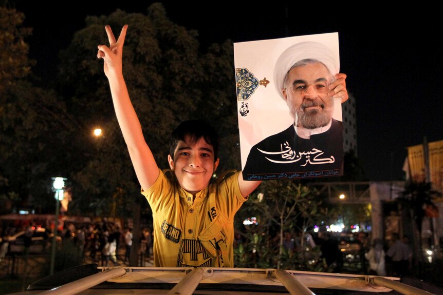 Supporter holds portrait of Hassan Rowhani.