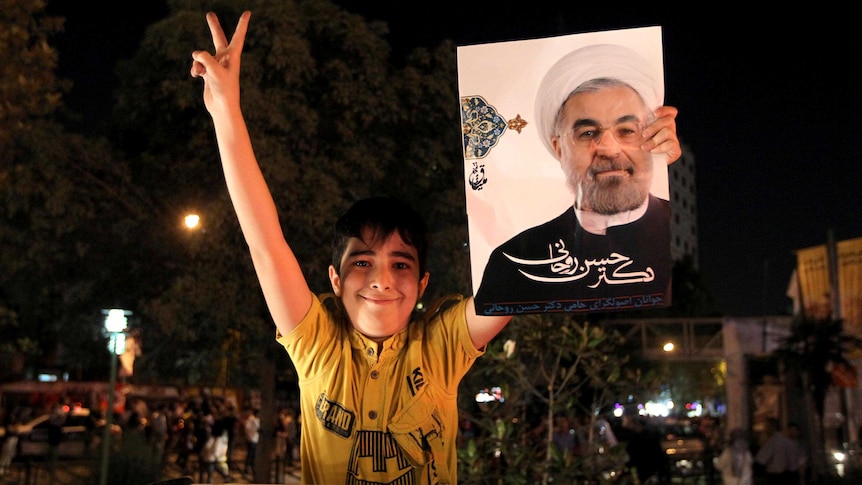 Supporter holds portrait of Hassan Rowhani.