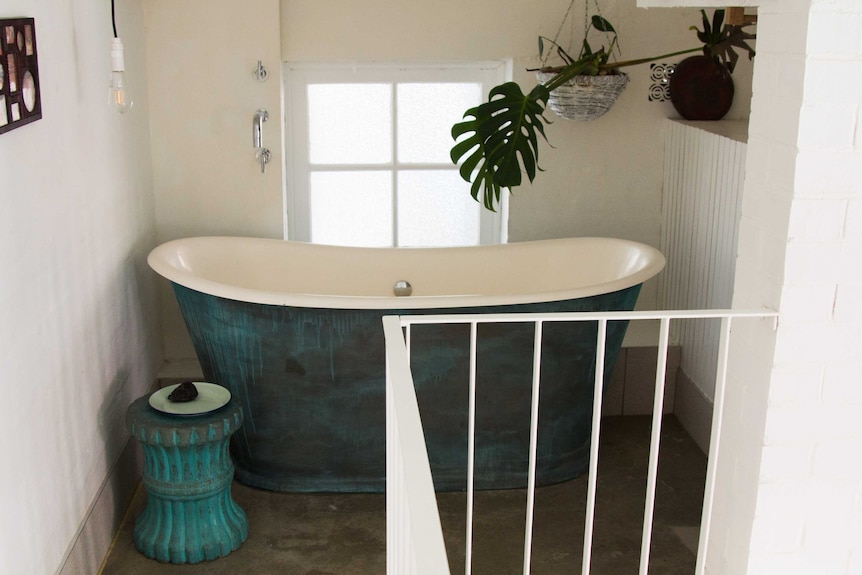 Bathtub on the upper level inside the tiny apartment