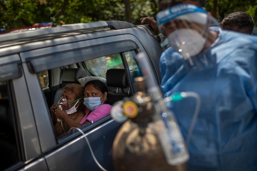 A patient receives oxygen inside a car provided by a Gurdwara, a Sikh place of worship, in New Delhi.