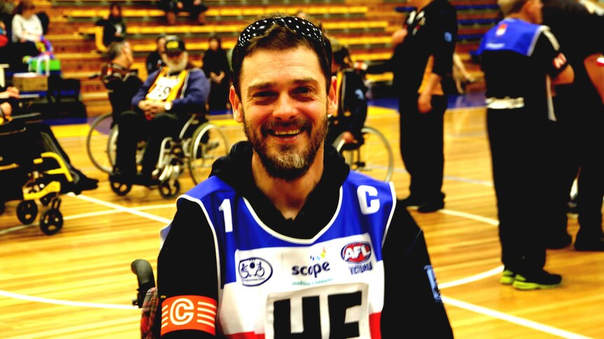 Jye Yates sits in his wheelchair on the court of the Bendigo Stadium waiting for the Grandfinal to begin.