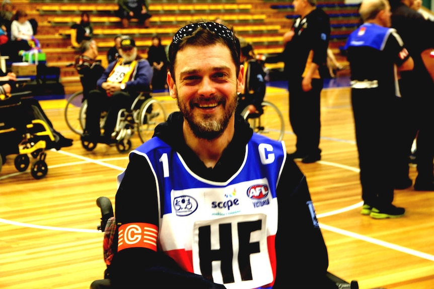 Jye Yates sits in his wheelchair on the court of the Bendigo Stadium waiting for the Grandfinal to begin.