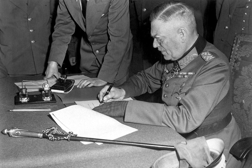 Wilhelm Keitel signing the definitive act of surrender in Berlin