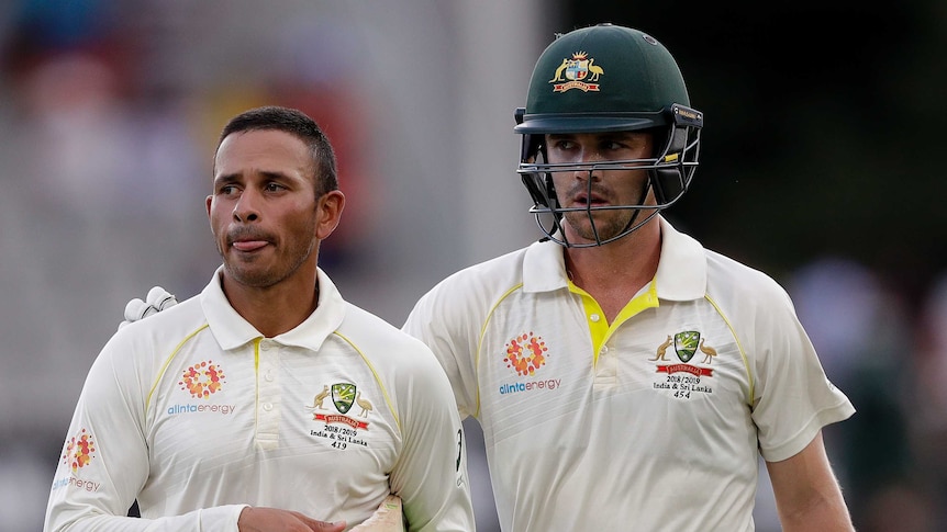 Usman Khawaja and Travis Head walk off the field after Australia's innings was declared