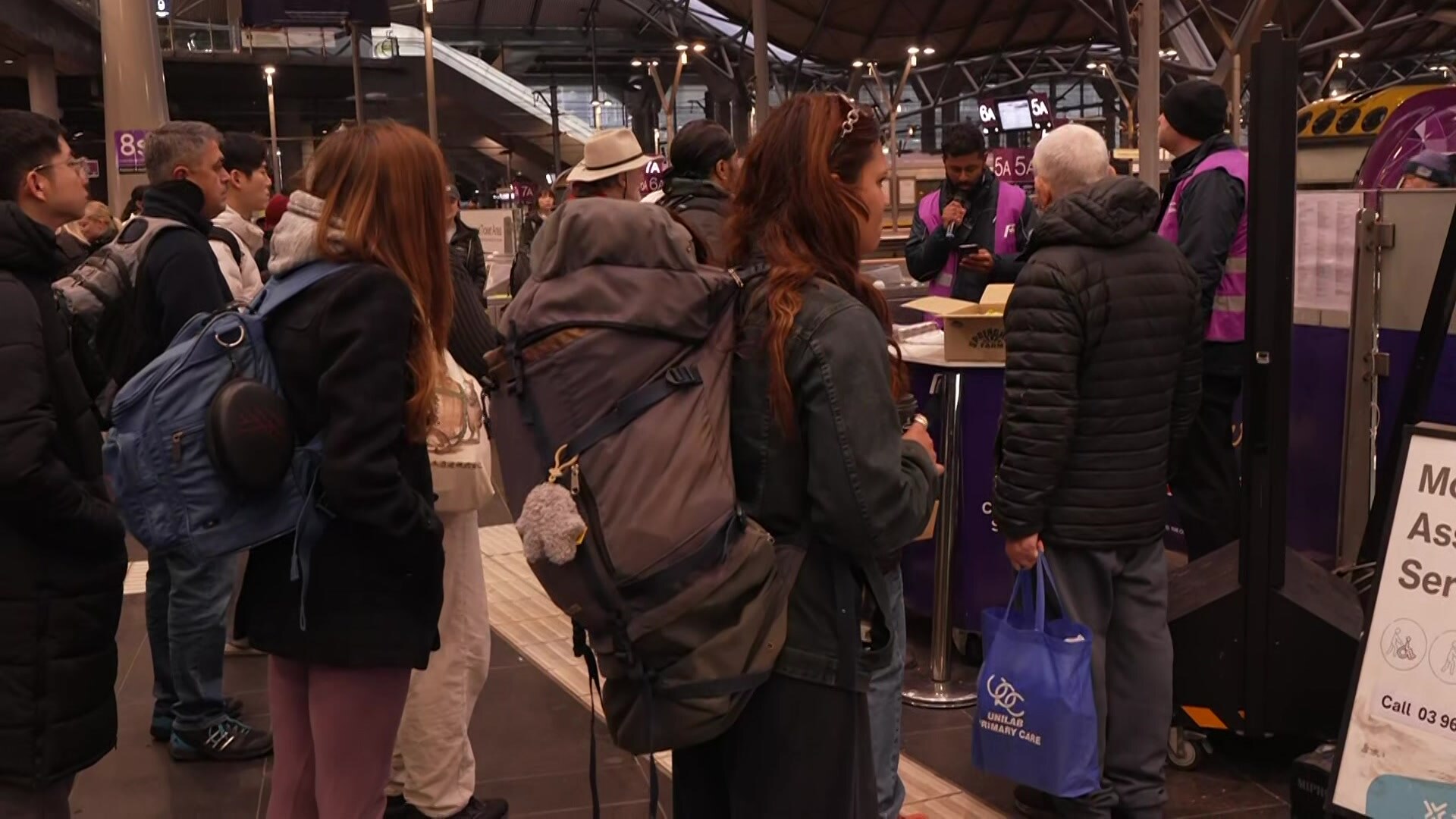 People near a train platform.