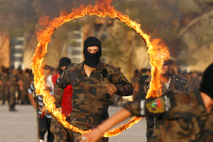 A member of the Libyan special forces performs after completing his training for the election.