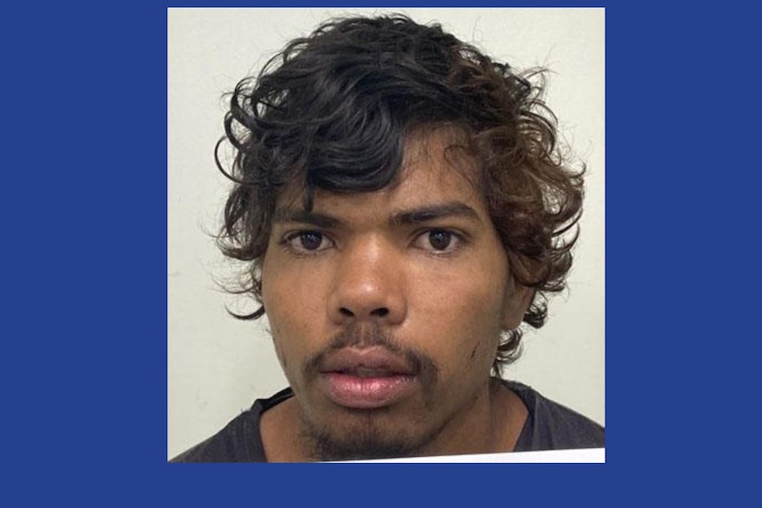 A police mug shot of a young Indigenous man