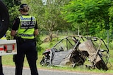 A photo shows a police officer with 'crash investigations' on their back in from of a crashed ATV.