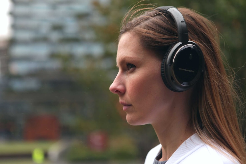 A woman wearing headphones.