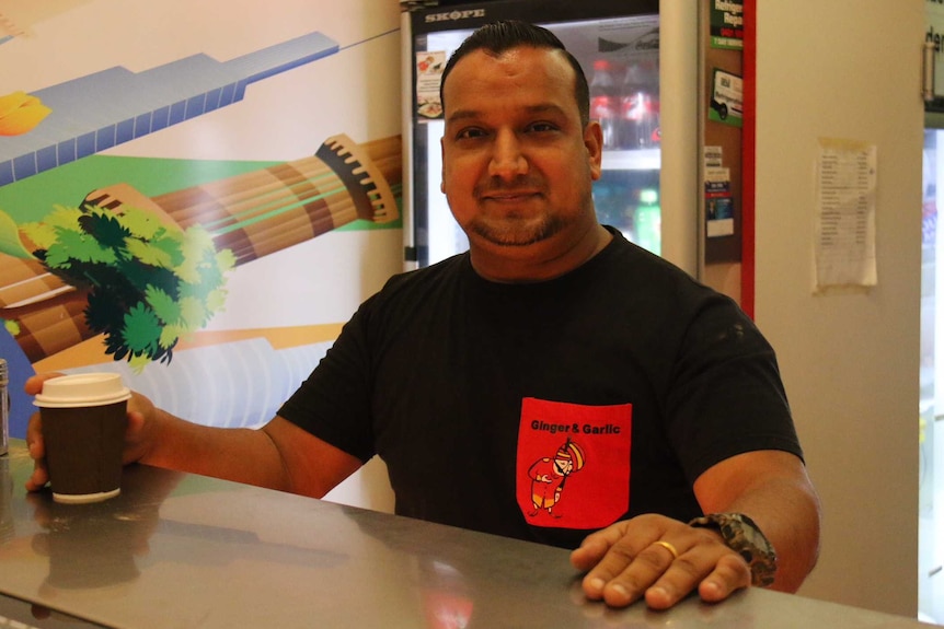 Ashish Sood leaning over a counter