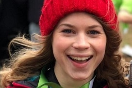 sarah everard smiles and holds a medal.