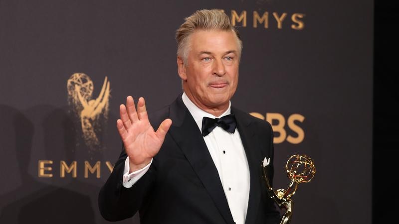 Alec Baldwin holds his Emmy and waves to the camera