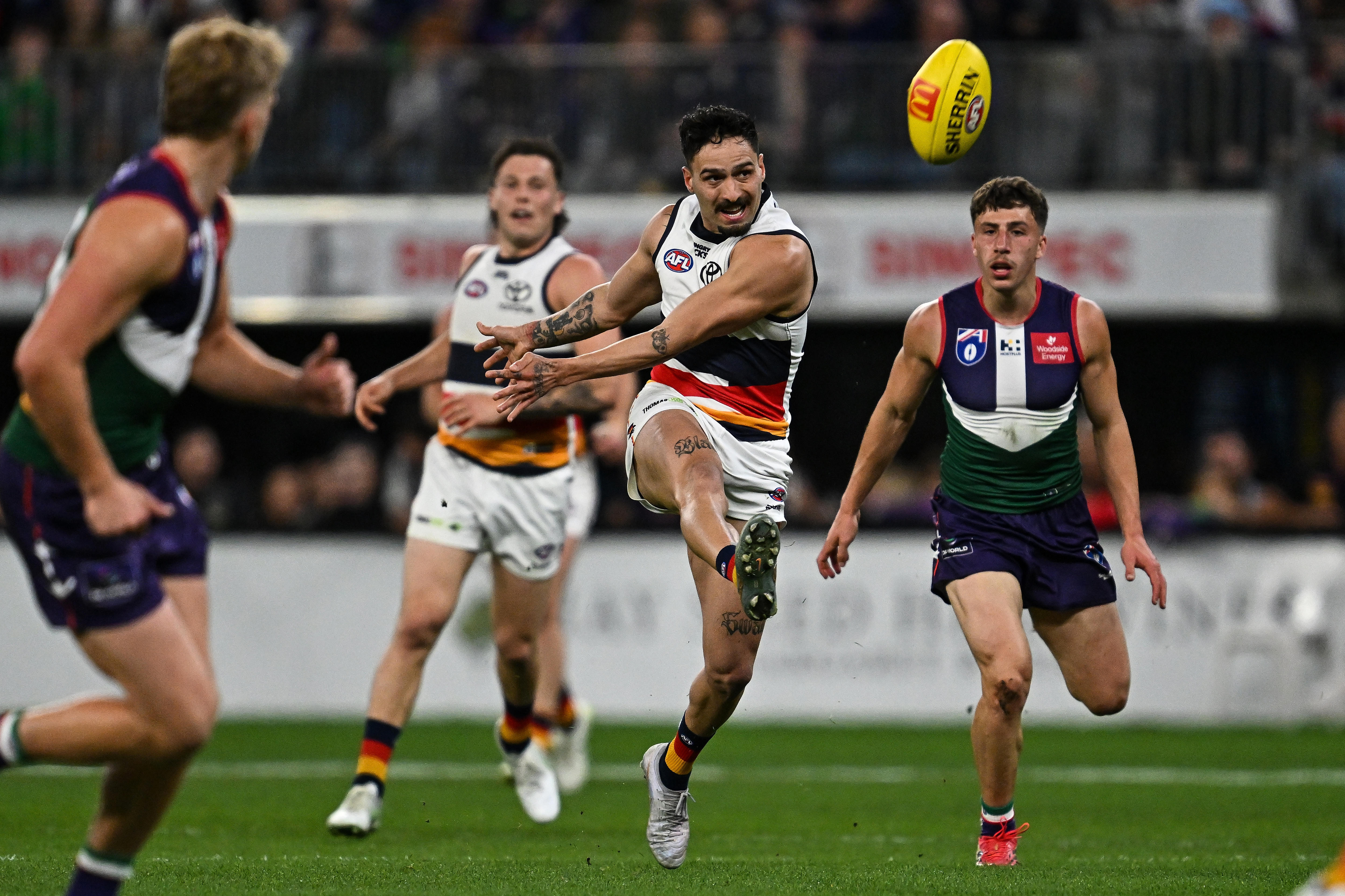 Izak Rankine kicks the football against Fremantle