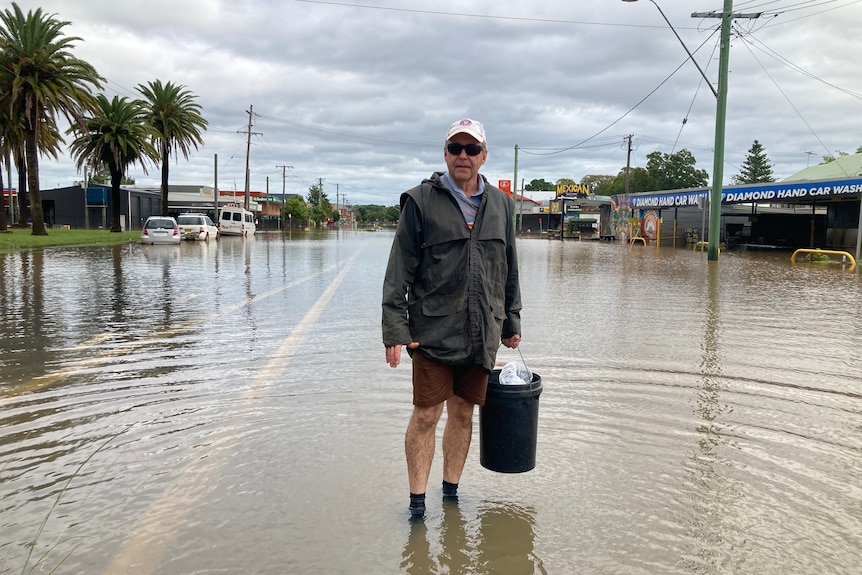man standing in flood water