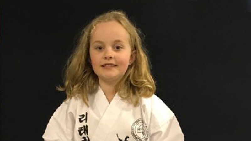 A photo of Rosie Andersen in a martial arts outfit.