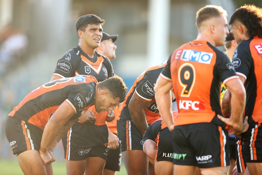 The Wests Tigers players stand and look upset