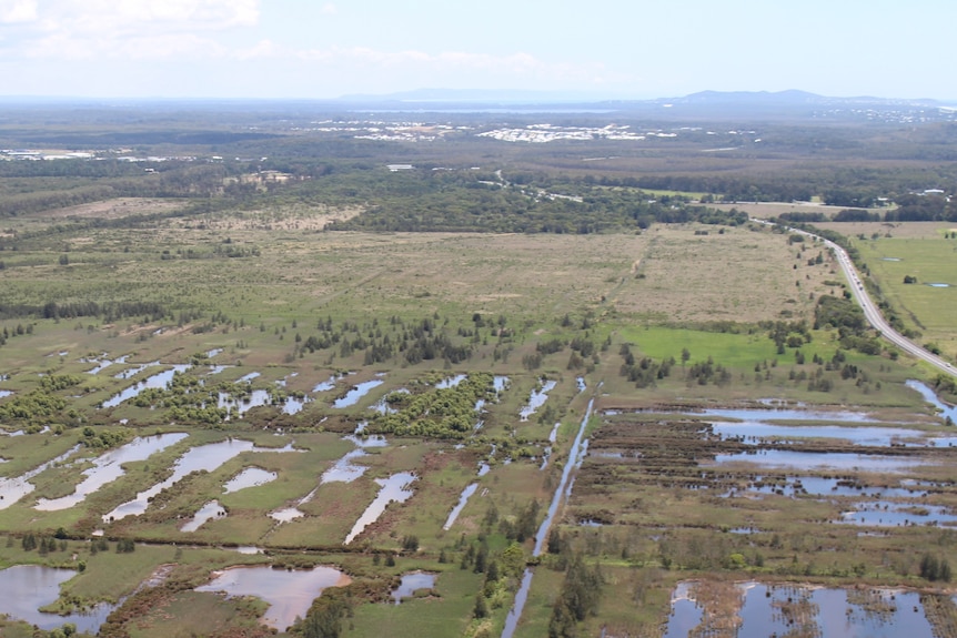 An aerial photo of a field, you can see where the water is lying in a paddock.