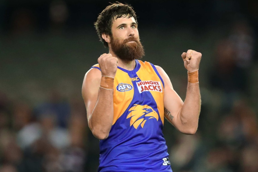 Josh Kennedy looks towards the crowd and holds both his fists aloft after kicking a goal.