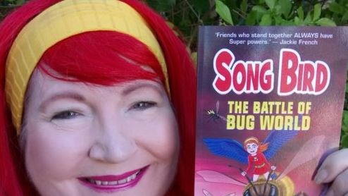 Childrens author karen tyrrell holds a copy of her new book Song bird: The battle of bug world