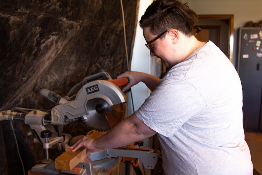 Kate O'Farrell cuts a piece of wood in her Rosny workshop