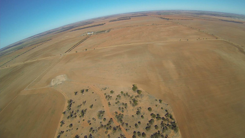 Oblique aerial shot of brown fields and sparse vegetation in WA.