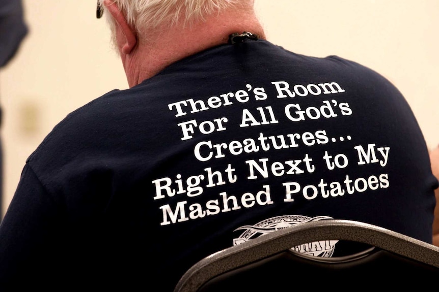 A man wears a slogan shirt at a meat festival in the United States.