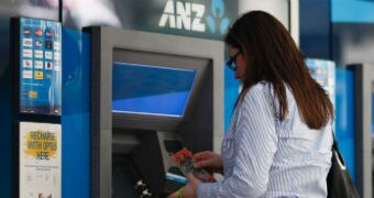 A woman withdraws cash from an ATM