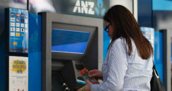 A woman withdraws cash from an ATM