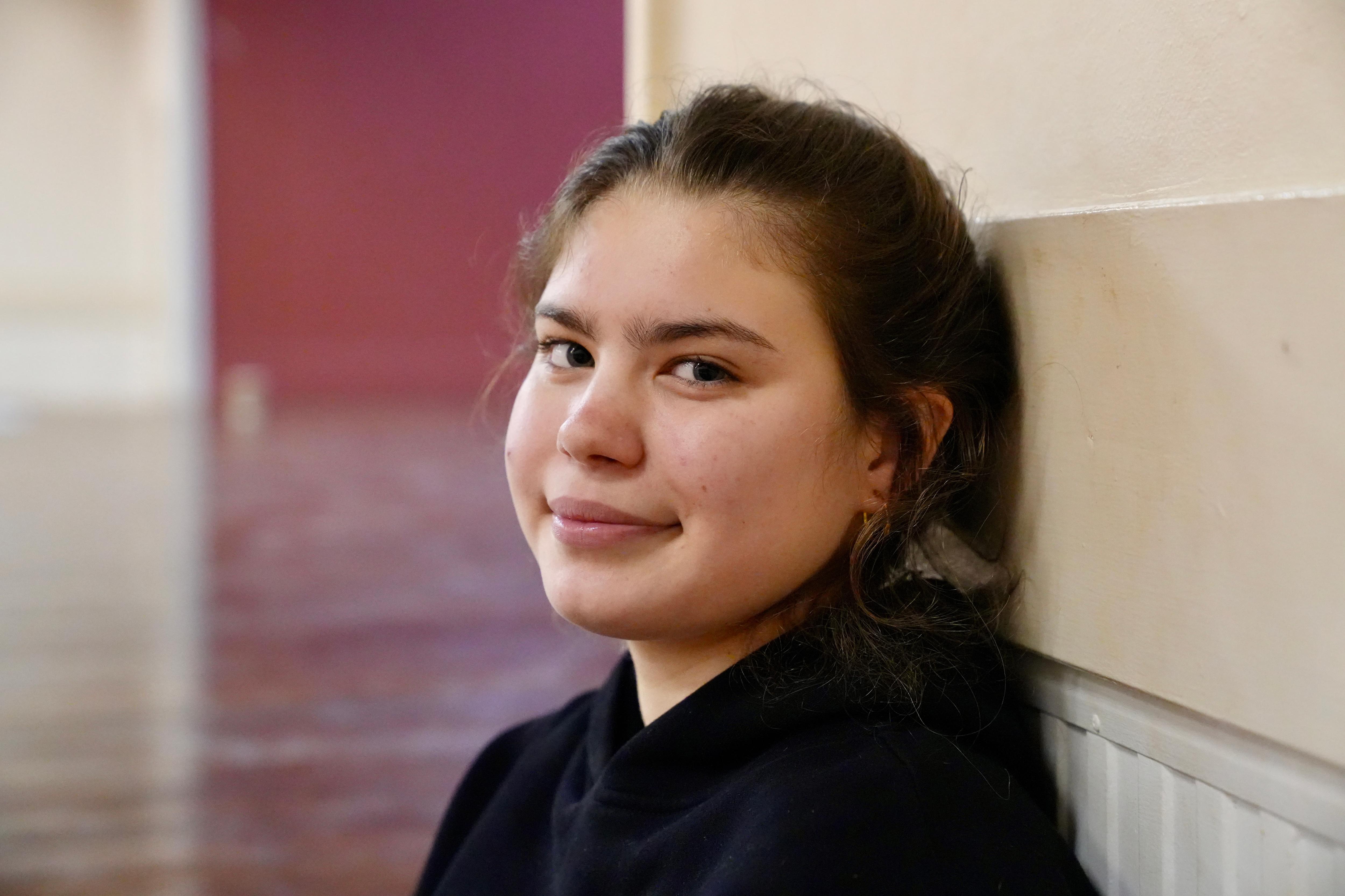 Teenage girl leaning against the wall 