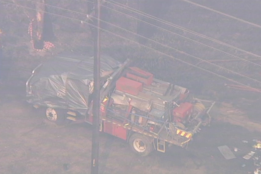 A fire tanker with silver tarp over it