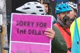 Extinction Rebellion protesters on bikes and holding signs on Hoddle St.