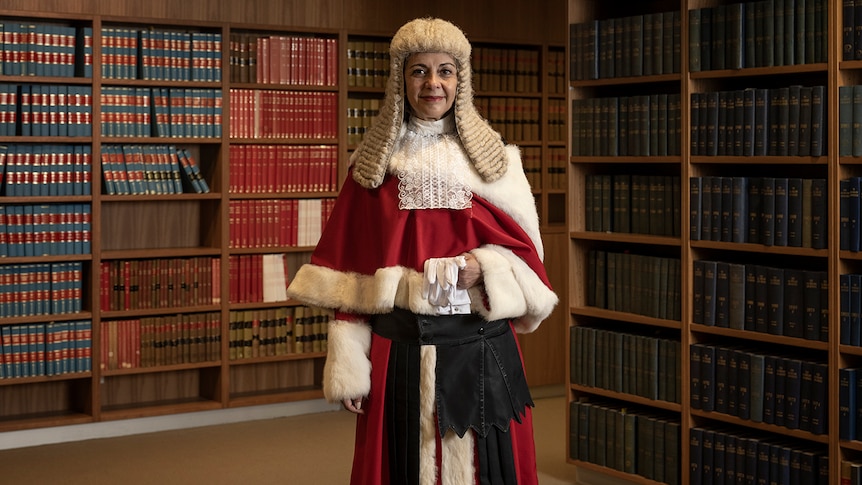 a female justice wearing a white wig and robes