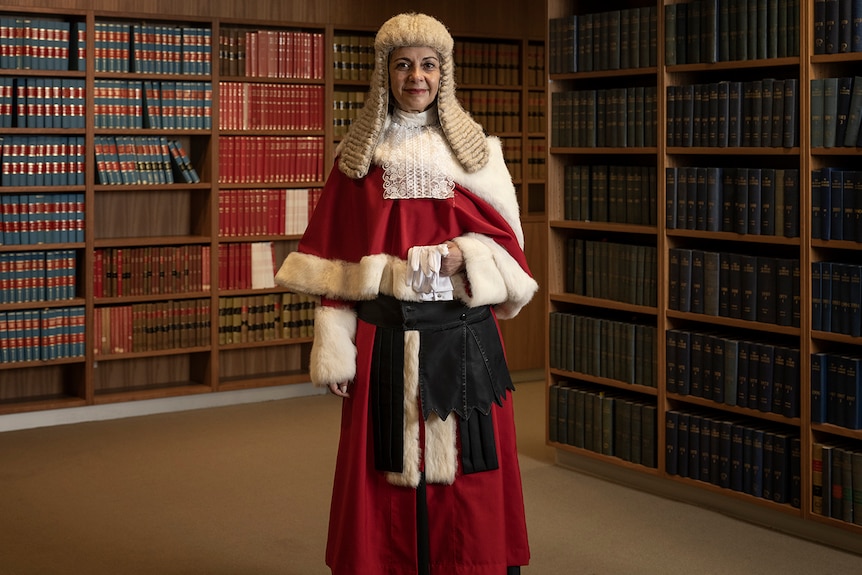 a female justice wearing a white wig and robes