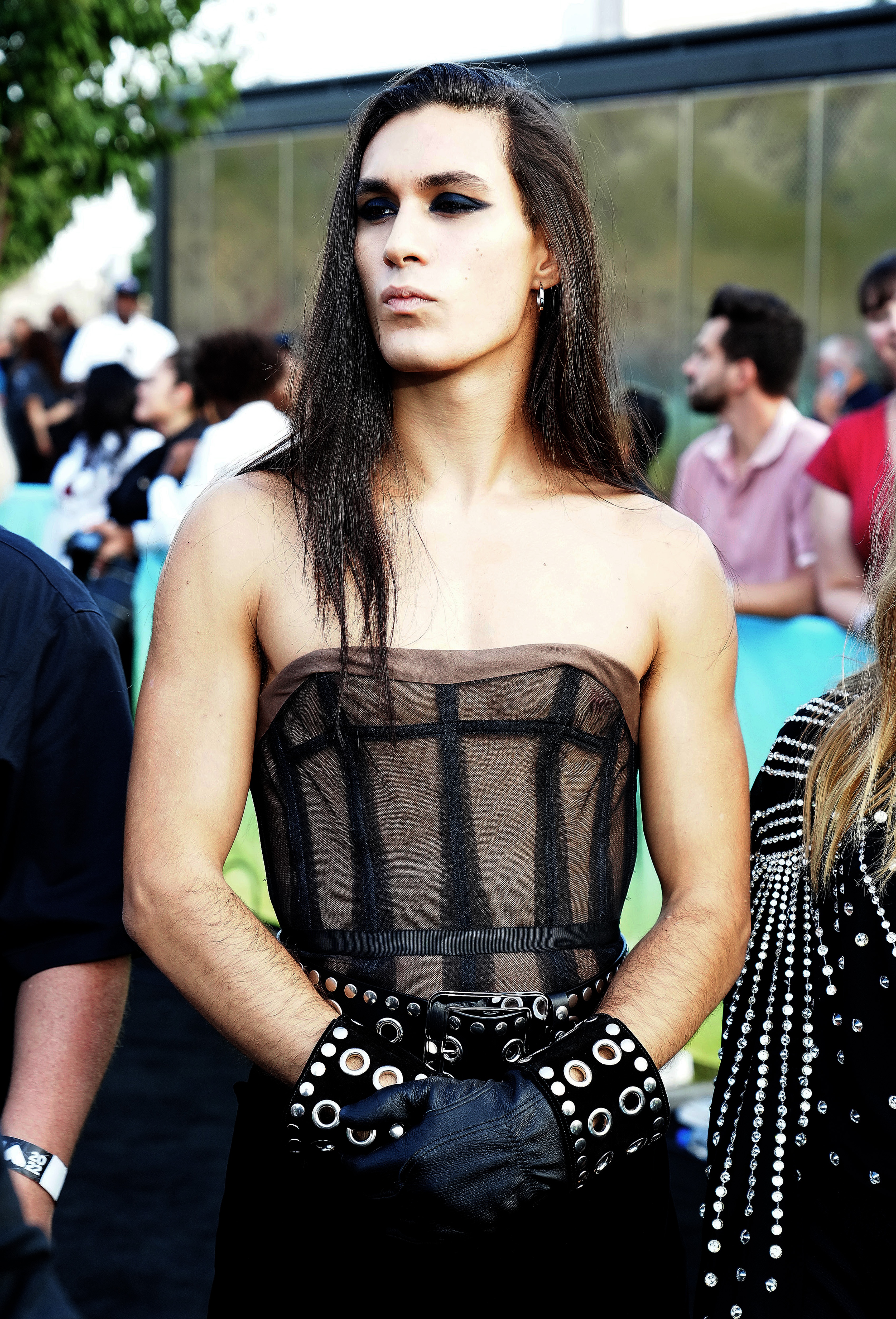 ethan torchio poses on the mtv vmas arrivals carpet wearing a sheer strapless corset and studded black cuffs