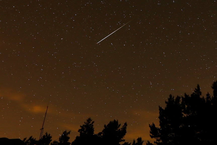 A streak of light in the night sky from a meteor