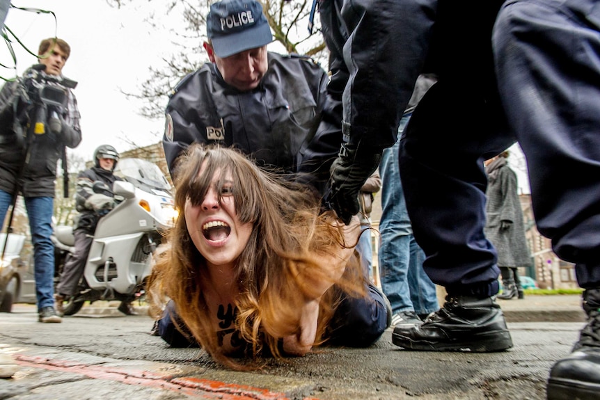 FEMEN activist protests against Dominique Strauss-Kahn
