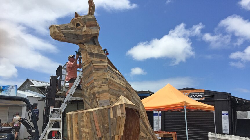Volunteers build a giant recycled wood kangaroo