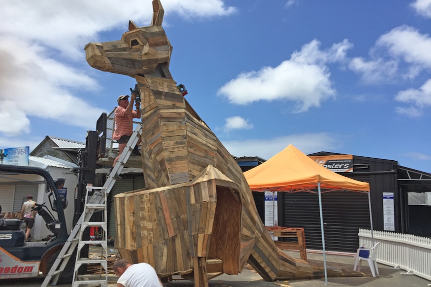 Volunteers build a giant recycled wood kangaroo